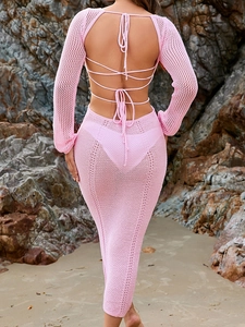 Detail of pink crochet knit dress featuring an open back with lace-up crisscross straps