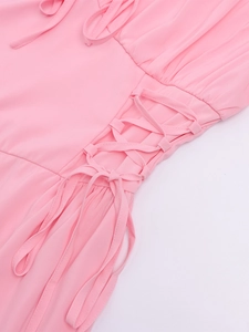Detail of pink puff sleeve dress with side lace-up drawstring and pleated texture