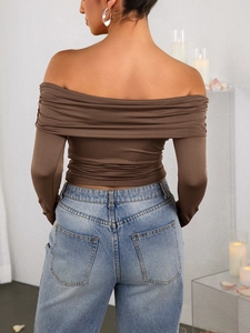 Macro detail of the back view of a slim fit backless brown top with ruched texture