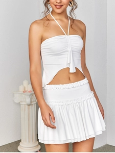 Detailed view of white milk silk set with halter ruched top and layered ruffle skirt