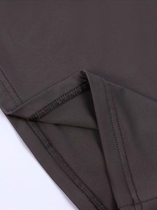 Detail shot of double-needle stitching and texture on a dark taupe milk silk top