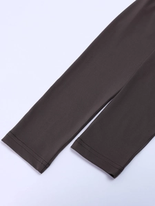 Detail of the precise double-needle stitching on a dark brown long-sleeve knit top