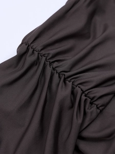 Macro shot of ruching detail on charcoal milk silk fabric with high-stretch texture