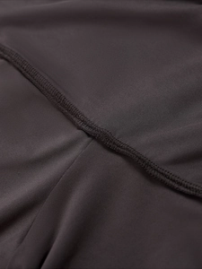 Macro shot of charcoal grey stretch fabric with professional flatlock stitching details