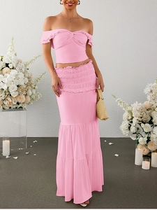 Detail of pink milk silk two-piece set featuring off-shoulder ruffle top and tiered cake skirt