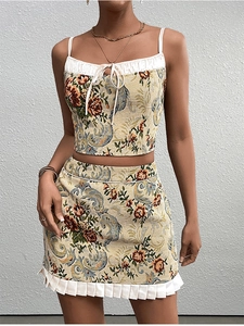 Detail of floral jacquard crop top with white ruffle trim and matching mini skirt set