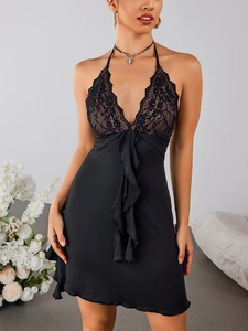 Close-up of elegant black lace patchwork and halter neckline on backless dress