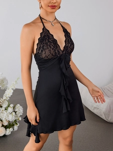 Detail of black lace V-neck bodice and satin fabric on backless halter lingerie dress