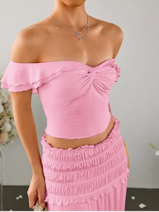 Detailed view of pink milk silk set featuring ruffled off-shoulder top and ruched maxi skirt