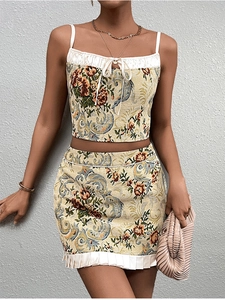 Close-up of floral jacquard fabric with white pleated trim and delicate bow detail