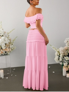 Detail of light pink two-piece set featuring an off-shoulder top and tiered ruffle maxi skirt