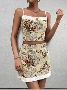 Detail of floral jacquard crop top with white pleated hem and matching mini skirt