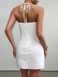 Close-up of white halter neck mini dress with back invisible zipper and tie-up design