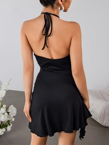 Back view of a black halter neck backless dress with lace trim and ruffled hem detail