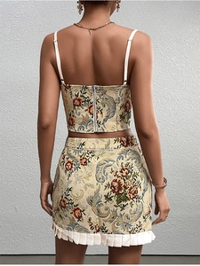 Detail of floral jacquard two-piece set featuring back zipper and white pleated hem
