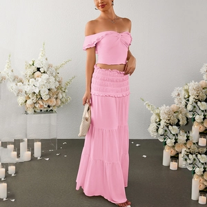 Pink off-shoulder crop top and tiered maxi skirt set for women in a romantic setting