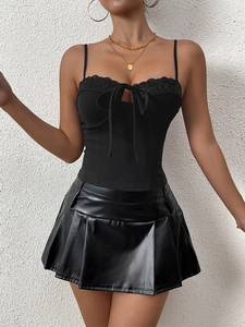 Detail showing black lace trim with bow tie on a slim fit cropped camisole top