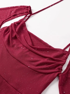 Detail of wine red mesh dress featuring silver glitter and draped cowl neck design