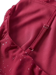 Detail view of adjustable silver-glitter burgundy dress strap with metallic buckle