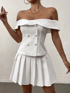 Close-up of a white off-shoulder slim top with double-breasted buttons and structured fabric