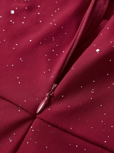 Macro shot of silver sequins on burgundy mesh fabric with a fine invisible zipper detail