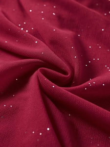 Macro shot of burgundy mesh fabric with silver glitter sequins and soft draped texture