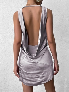Detail of elegant silver-purple satin mini dress showing low back design and draped collar