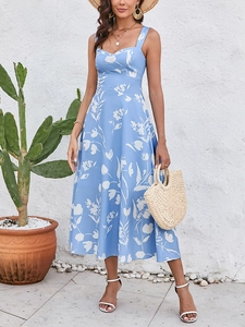 Outdoor view of a light blue floral midi dress with heart neckline and wide straps