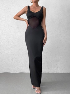 Close-up of black bodycon dress featuring mesh patchwork and a sheer V-cut waist detail