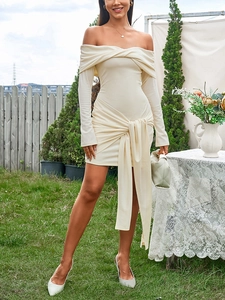 Detail of off-white off-shoulder knit dress with elegant twist neckline and long waist tie