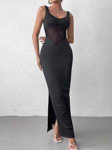 Detail of black maxi dress featuring mesh patchwork waist and high side slit design