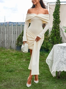 Detail of off-shoulder knitted mini dress featuring a knot neckline and long ribbon ties