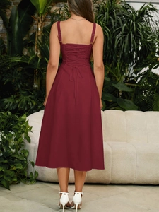 Detailed back view of a burgundy midi dress featuring a stylish lace-up crisscross design