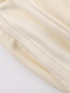 Detail of off-white knit dress showing smooth lining and anti-slip silicone strip