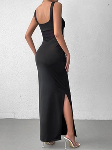 Detail view of backless black dress featuring mesh waist panels and a side high slit