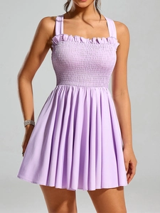 Detail view of smocked lavender summer dress with delicate ruffled trim and pleated texture