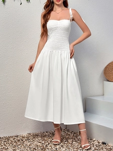 Detailed view of the white smocked bodice with adjustable tie-up shoulder straps