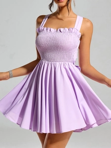 Detail of lavender mini dress featuring elastic pleated bodice and ruffle neckline design