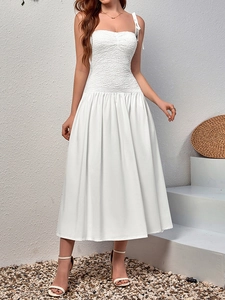 Detail of adjustable bow shoulder straps on elegant white smocked lace dress