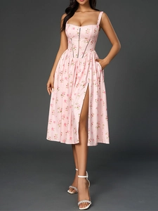 Close-up of pink floral print dress showing the corset bodice and high slit detail