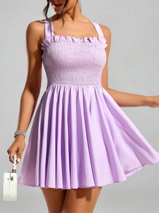 Detail of lavender smocked mini dress with ruffle trim and elastic A-line pleated skirt