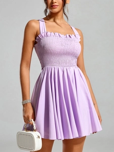 Detail of lavender smocked bodice with ruffled edges on a summer backless dress