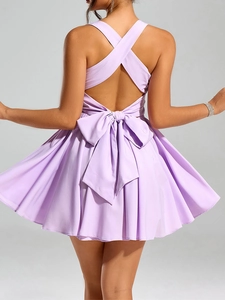 Detail of lavender backless dress showing cross straps and oversized bow tie on the back