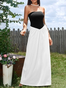 Detail of elegant tube top dress showing black bodice and white high waist long skirt contrast