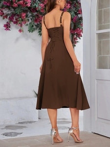 Detail view of the back lace-up closure and slim straps on a floral print midi dress