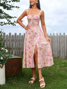 Detail of pink floral midi dress featuring front drawstring and side slit design