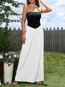 Close-up of the V-shaped waistline seam joining the black bodice and white maxi skirt