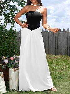 Detail of elegant black and white color block strapless maxi dress in garden setting