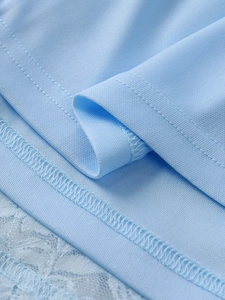 Detailed macro view of light blue lace trim and breathable fabric with neat stitching