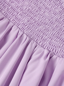 Detail shot of purple smocking technique on a strap dress with elasticated pleated fabric